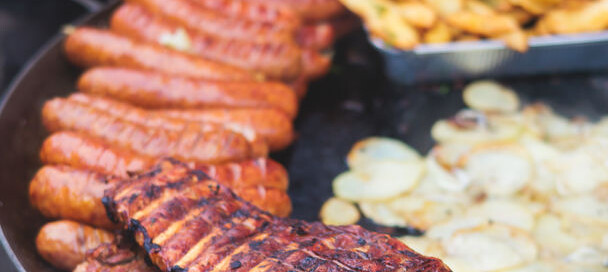 Catered BBQ food on grill at a Detroit event
