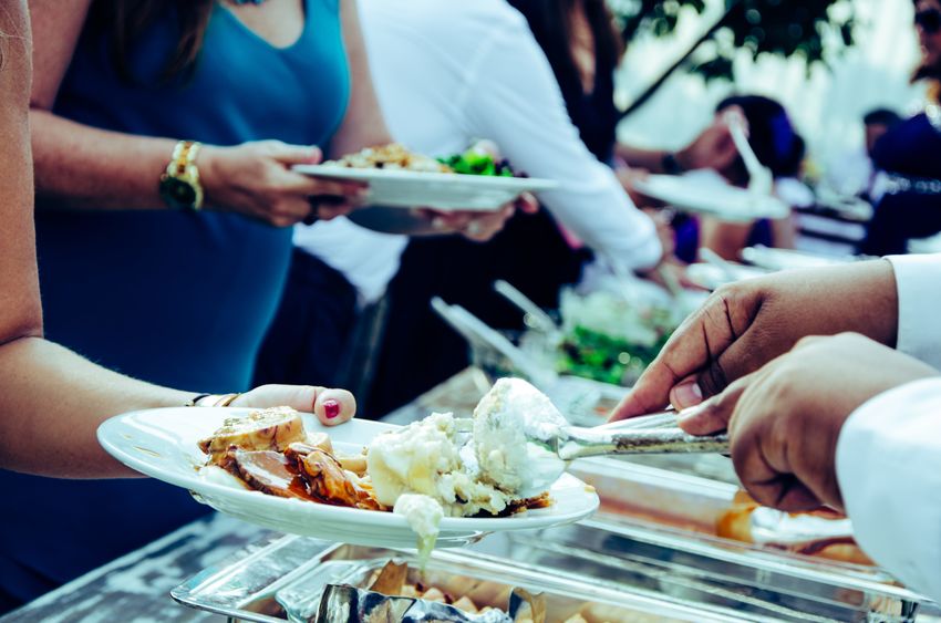 Professional caterers serving guests at an event.